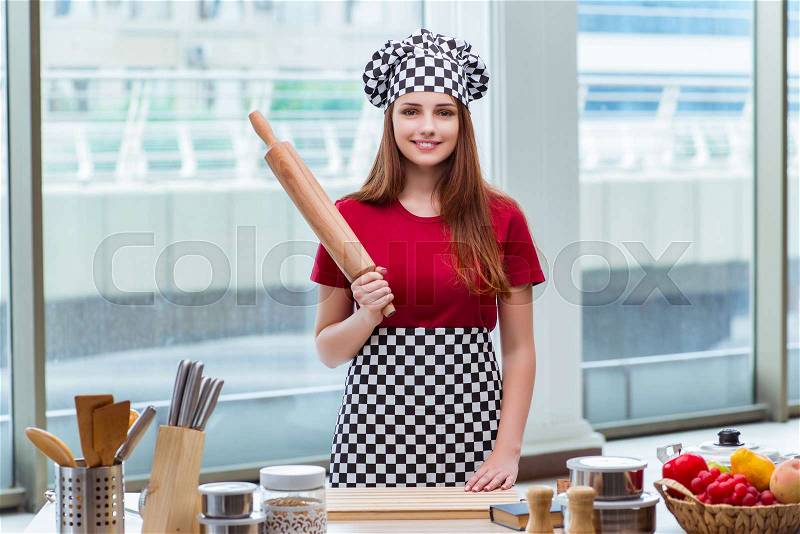 Woman with rolling pin isolated on white, stock photo