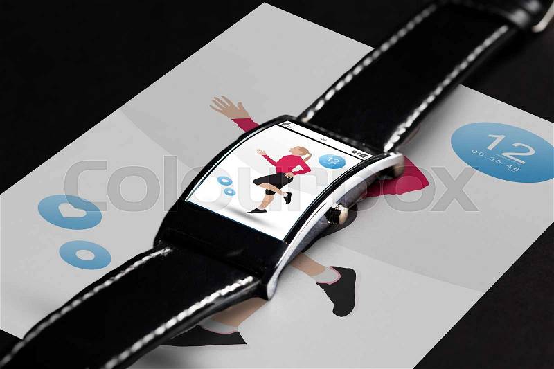 Modern technology, sport, object and media concept - close up of black smart watch with fitness application on screen, stock photo