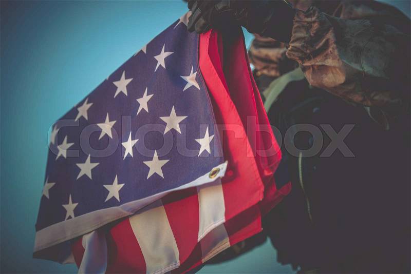 Folded American Flag in Soldier Hands Closeup Photo, stock photo