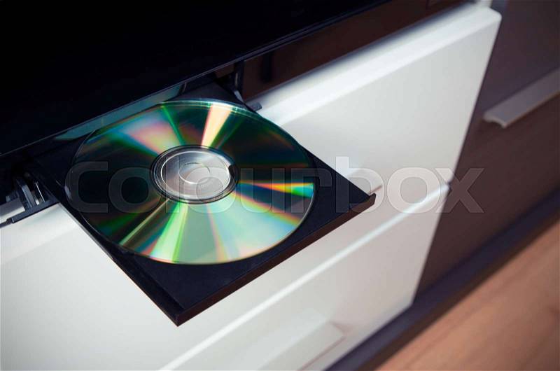 Close up of CD or DVD player with inserted disc, stock photo