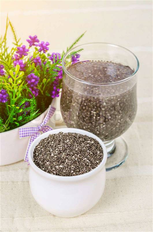 Chia seeds and chia seeds in water on tablecloth, stock photo