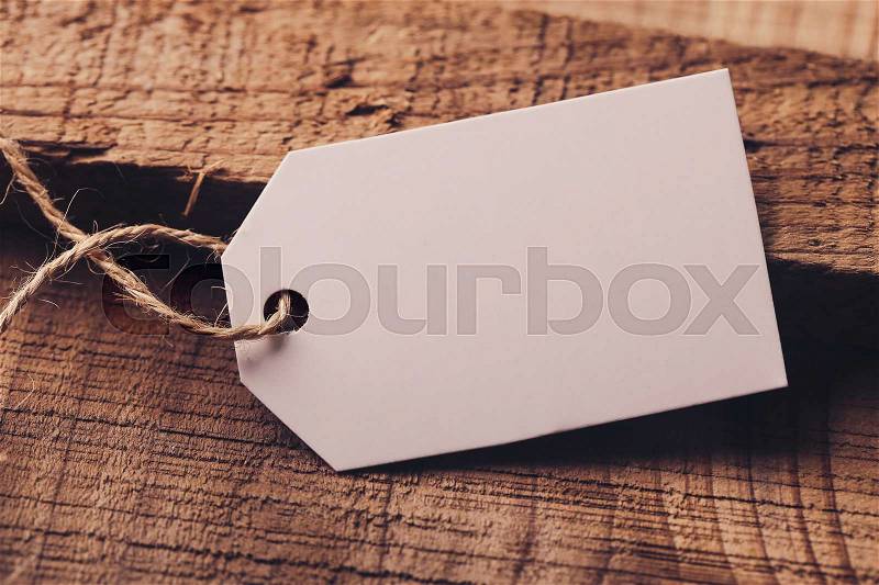 Blank white label is on the wood for your edit, stock photo