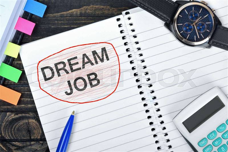 Dream Job text on notepad and watch on desk, stock photo
