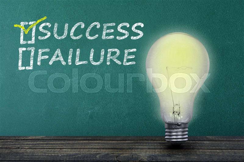 Success text on green board and light bulb on table, stock photo