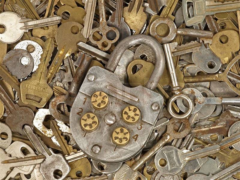 Old lock on a lot metal keys background, stock photo