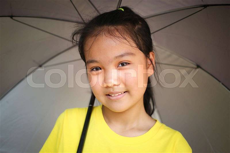 Smiling of Asian teen with big umbrella, stock photo