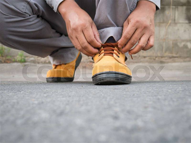 Close up of The man wears safety shoes on street , stock photo