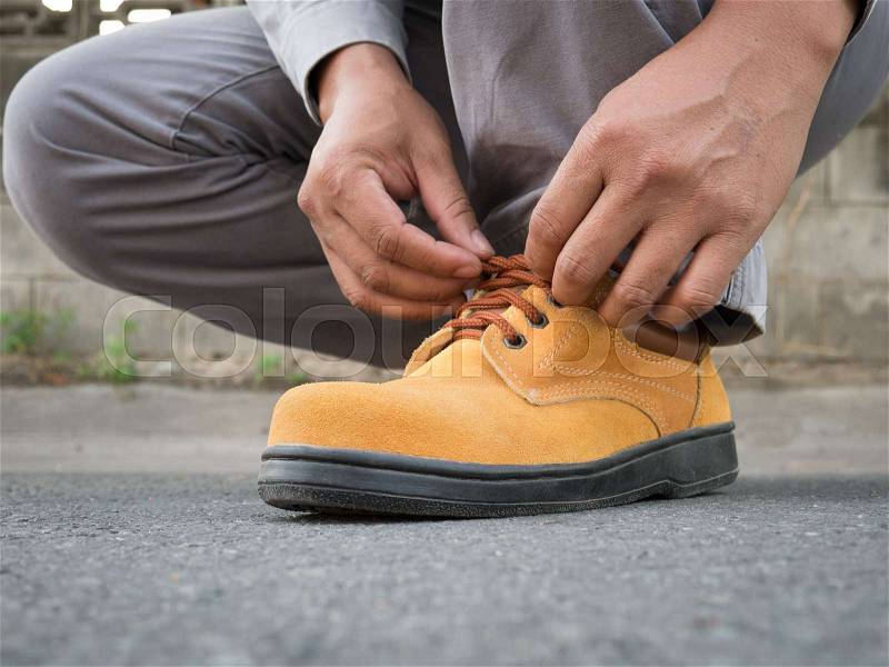 Close up of The man wears safety shoes on street , stock photo