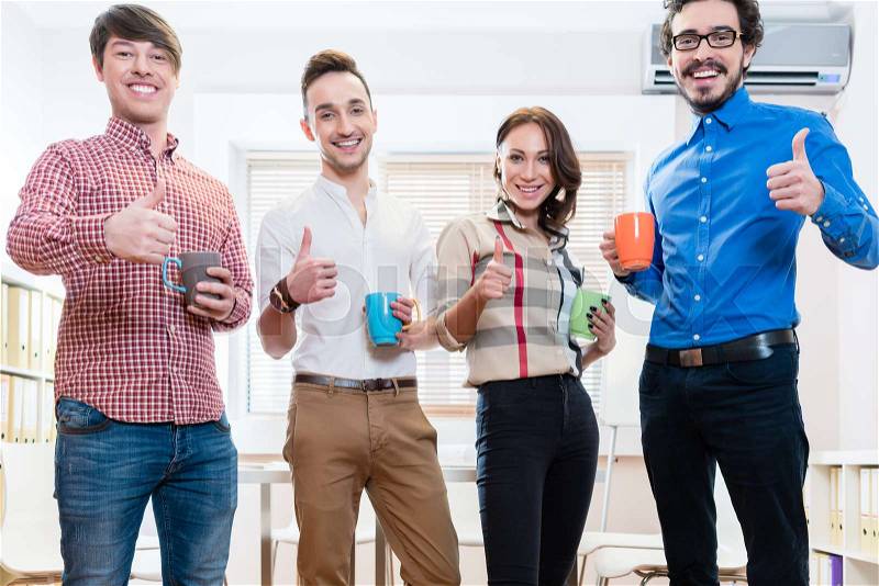 Young creative entrepreneurs being motivated, one woman and three men, stock photo
