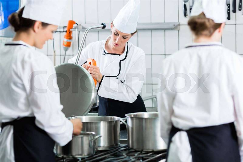 Canteen kitchen with chefs during service, stock photo