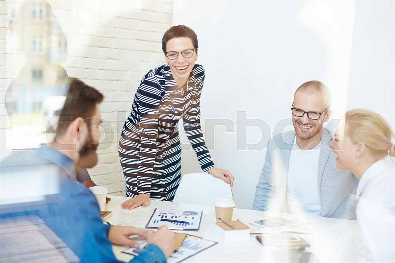 Successful managers laughing during discussion of work, stock photo