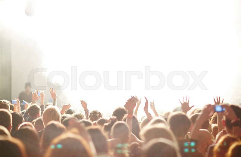 People in front of bright stage lights, stock photo