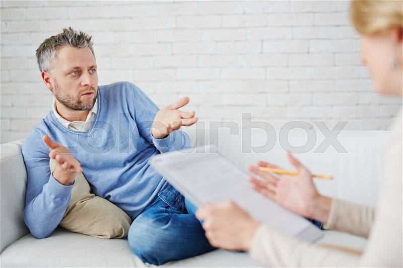 Man describing his problem to psychologist, stock photo