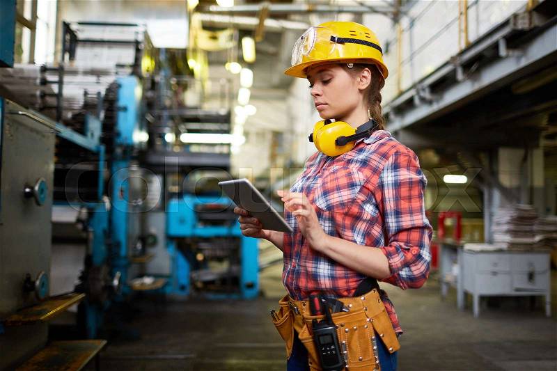 Female engineer using digital tablet for work, stock photo