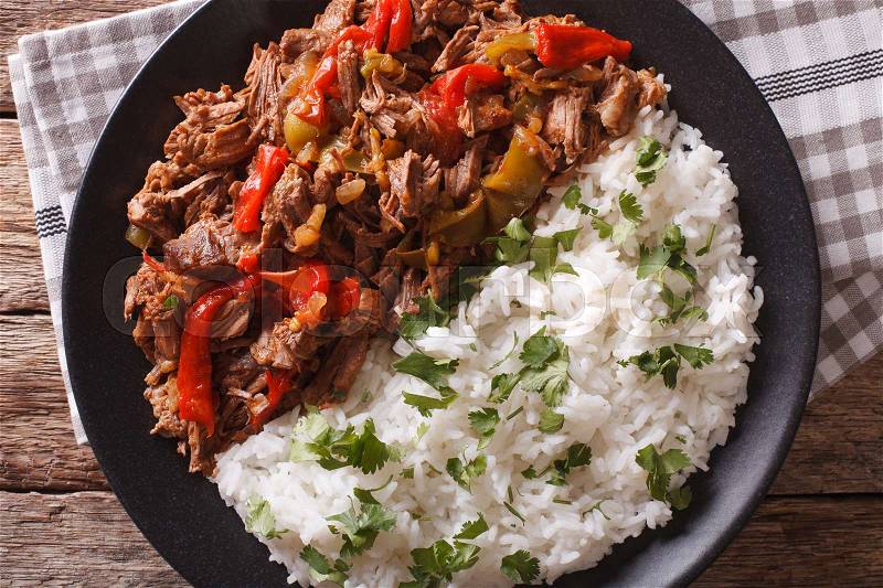 Latin American cuisine: ropa vieja with rice close-up on a plate. Horizontal view from above , stock photo