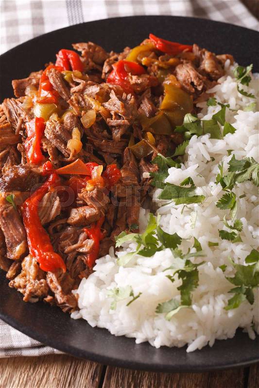 Latin American cuisine: ropa vieja with rice close-up on a plate. vertical\, stock photo