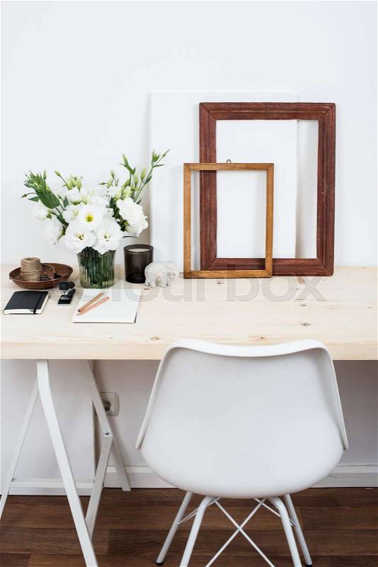 Stylish scandinavian interior design, white workspace with desk and chair, trendy artist studio decor, stock photo