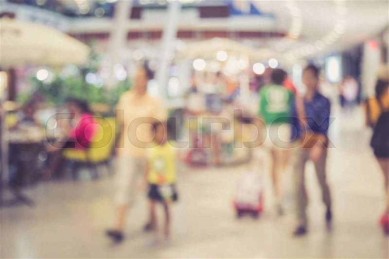 Abstract blurred image of people in shopping mall with bokeh, vintage color, stock photo
