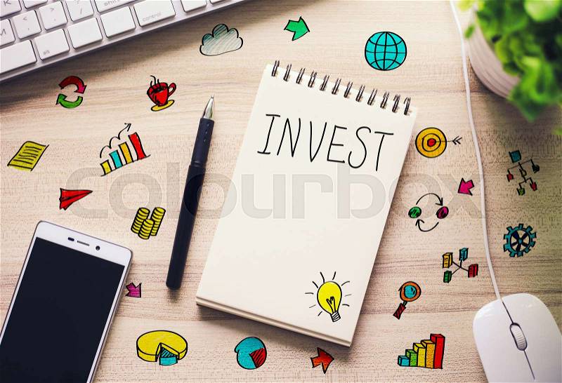 Invest business concept on the office desk with some business icons around, stock photo