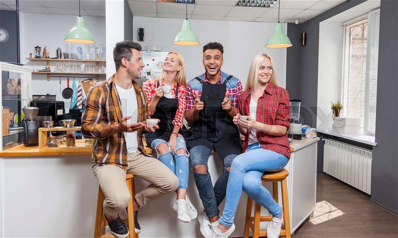 People friends drinking coffee shop talking laughing with barista sitting at bar counter, mix race man and woman happy smile, stock photo