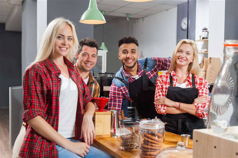 People friends drinking coffee shop talking laughing with barista sitting at bar counter, mix race man and woman happy smile, stock photo
