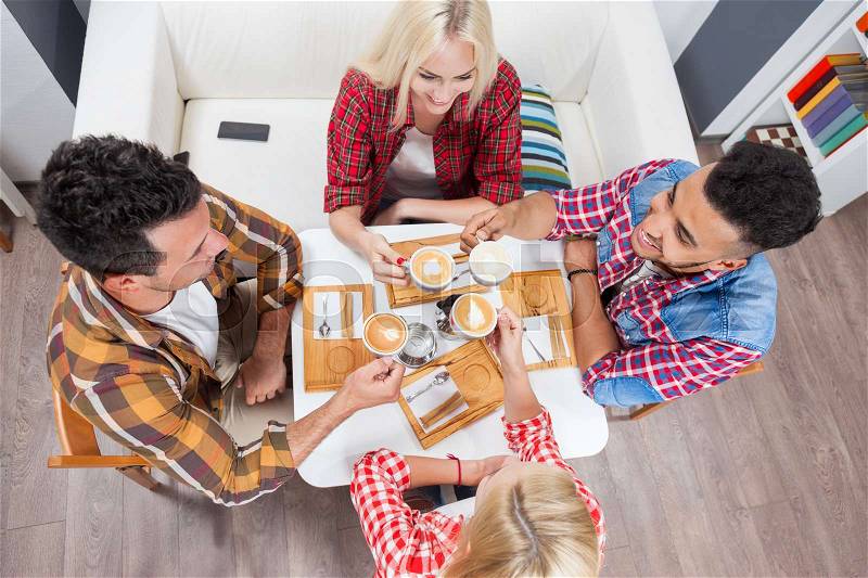 Young people drink coffee shop, friends sitting table smiling two couple mix race men women talking top angle above view, stock photo