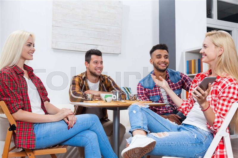 Young people drink coffee shop, friends sitting table smiling two couple mix race men women talking, stock photo