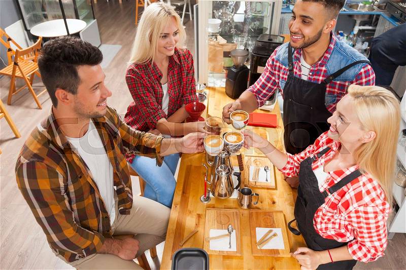 Barista serving clients give cup coffee shop bar counter, mix race man and woman happy smile to customer top angle above view, stock photo