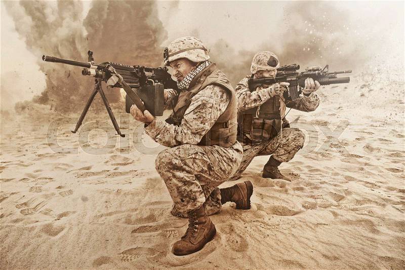 Two US marines aim at different directions covering each other, stock photo