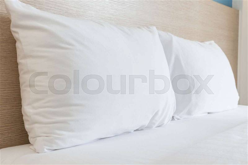 Close up white bedding sheets and pillow in hotel room, stock photo