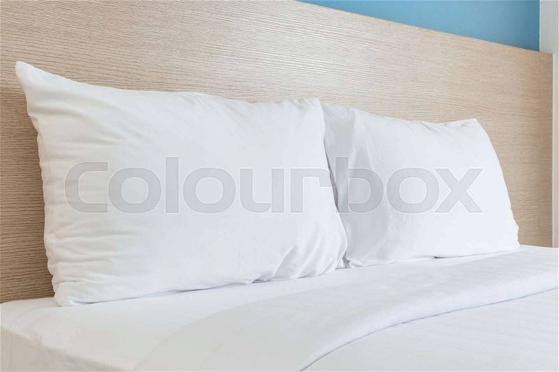 Close up white bedding sheets and pillow in hotel room, stock photo
