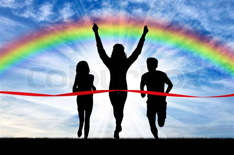 Runners, rainbow, sport. Winning runner crosses the red tape on the background of the rainbow, stock photo