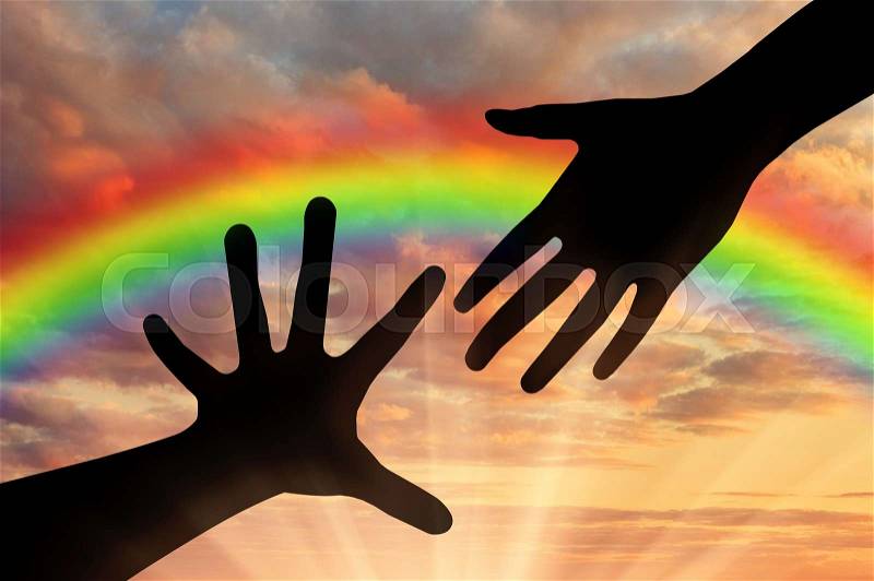 Helping hand concept. Helping Hand of God against the backdrop of a rainbow sky, stock photo