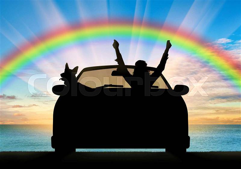 Travel and freedom. Happy man in the car with the dog on the sea sunset and rainbow, stock photo