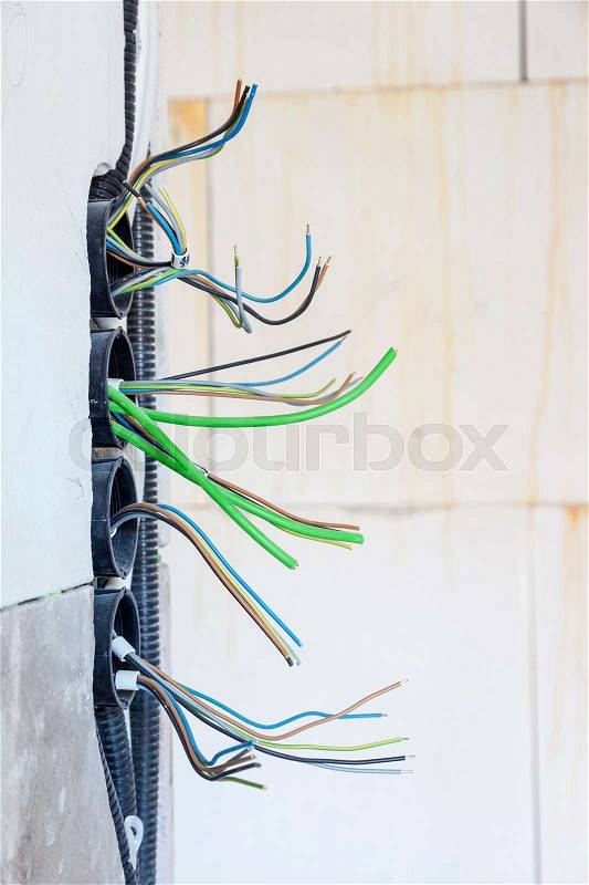 Cables and pipes in the wall of a new house, stock photo
