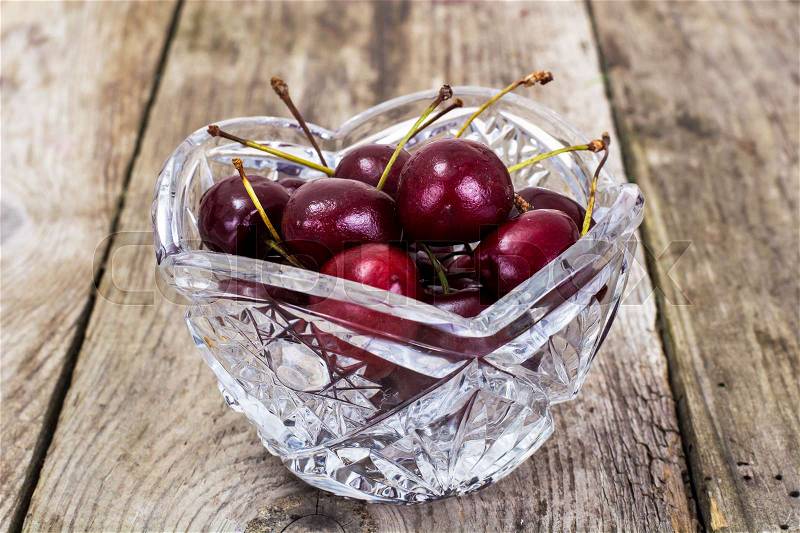 Cherries in Crystal Bowl on Rustic Wooden Background, stock photo