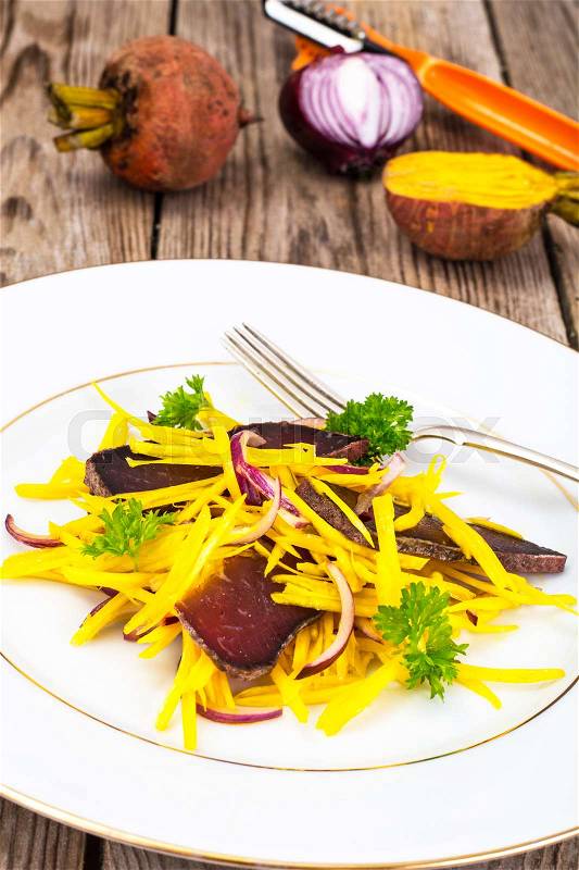Salad of Yellow Beets with Red Onion and Beef Jerky Studio Photo, stock photo