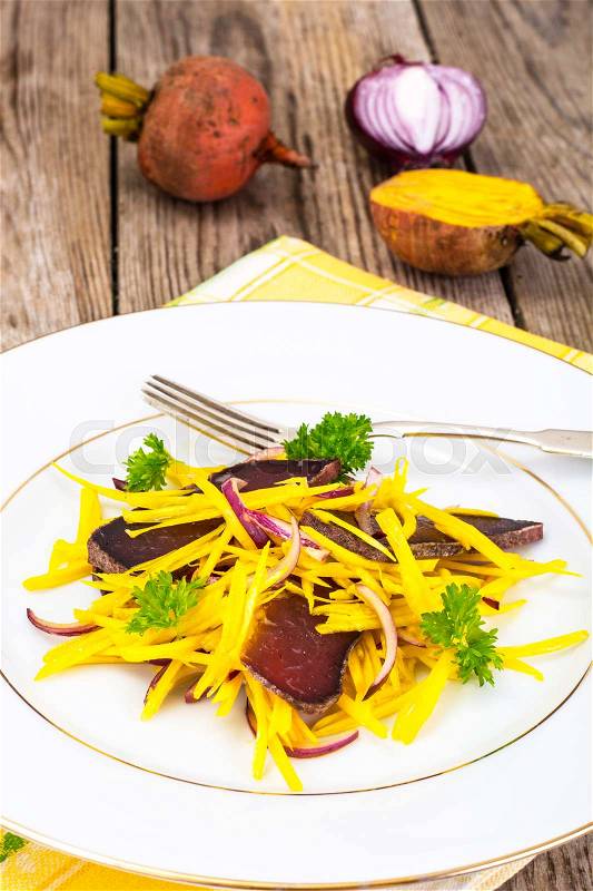 Salad of Yellow Beets with Red Onion and Beef Jerky Studio Photo, stock photo