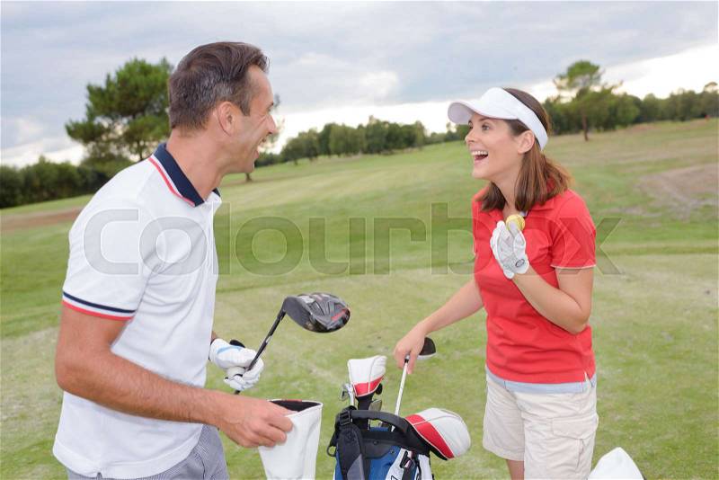 Couple on golf course, stock photo