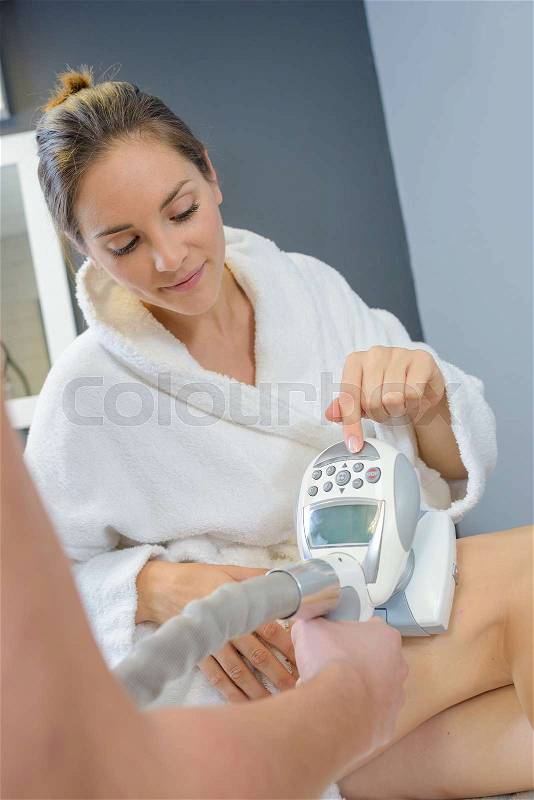 Woman setting machine in beauty salon, stock photo