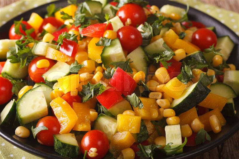 Low calorie salad of corn, tomatoes, cucumbers and pepper close-up on the table. horizontal , stock photo
