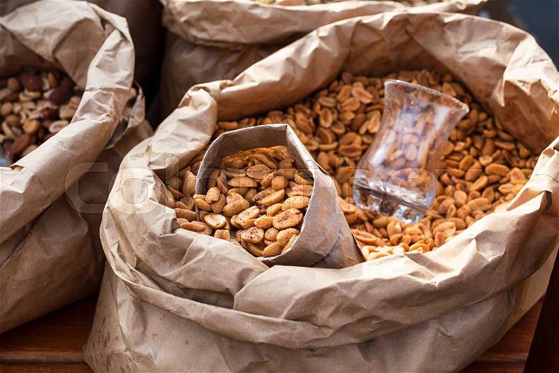 Salted peanuts in a paper bag closeup. Street food, stock photo
