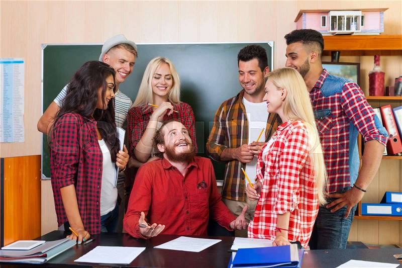 Student High School Group Laughing With Professor Sitting At Desk, Young People Teacher Discuss Communicate University Classroom, stock photo