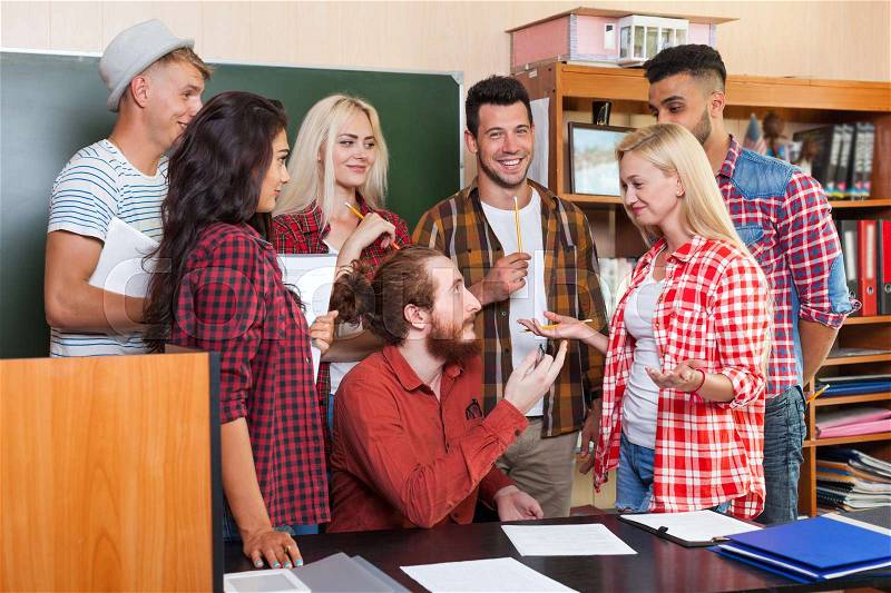 Student High School Group Talking With Professor Sitting At Desk, Young People Teacher Discuss Communicate University Classroom, stock photo