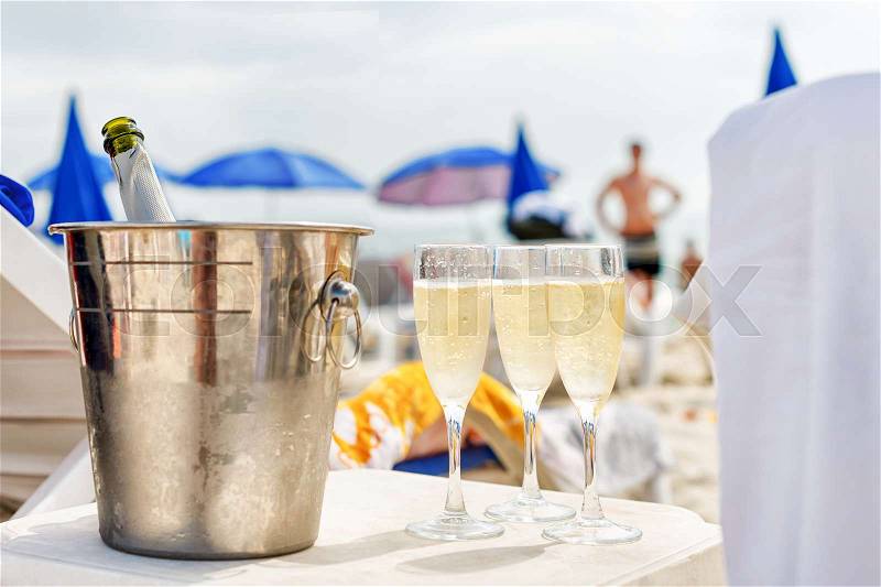 Cold champagne on the beach. Summer holiday relax, stock photo