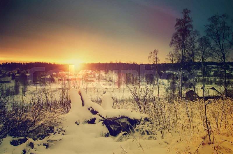 Winter sunny sunrise landscape with trees and small swedish town, north scandinavian seasonal hipster background, stock photo