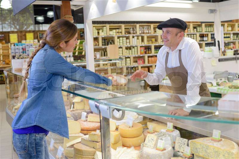 Service at the French cheese counter, stock photo