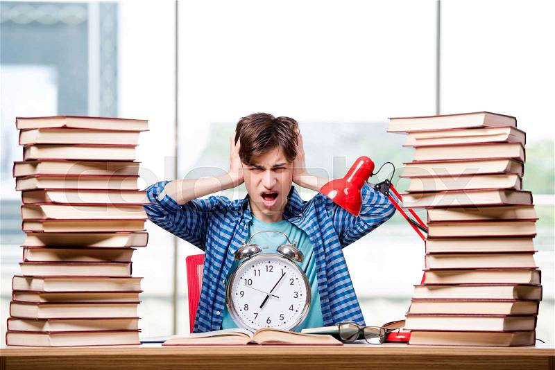 Student with lots of books preparing for exams, stock photo