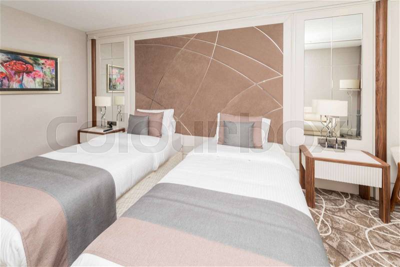 Modern hotel room with big bed, stock photo
