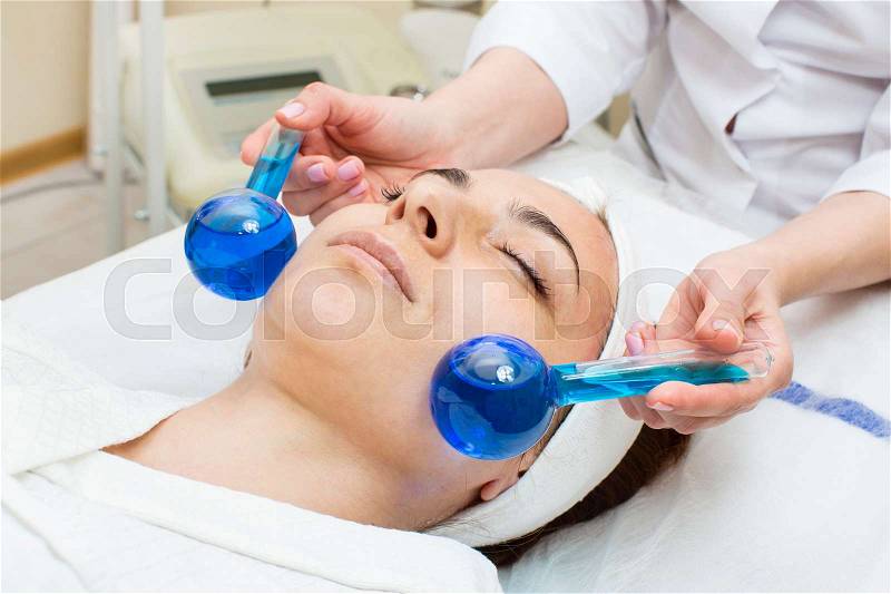 Process of massage and facials in beauty salon, stock photo